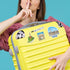MUNICH, Bavarian hat, arch stamp and Marienplatz stickers on a yellow suitcase held by a woman