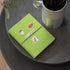 White BBQ sauce, pecan pie and 'ALABAMA' stickers on a green leather journal cover