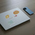 White laptop lid with St. Louis stickers: a ST. LOUIS wordmark, St. Louis-style pizza, gooey butter cake and a MetroLink map.