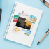 'The Hill' badge, Saint Louis Art Museum and gooey butter cake stickers in a lined spiral notebook.