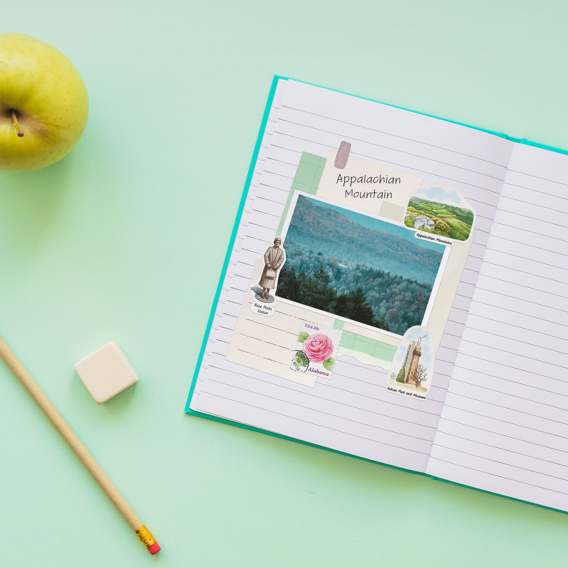 Rosa Parks statue, camellia stamp and Vulcan Park stickers around a photo in a lined notebook