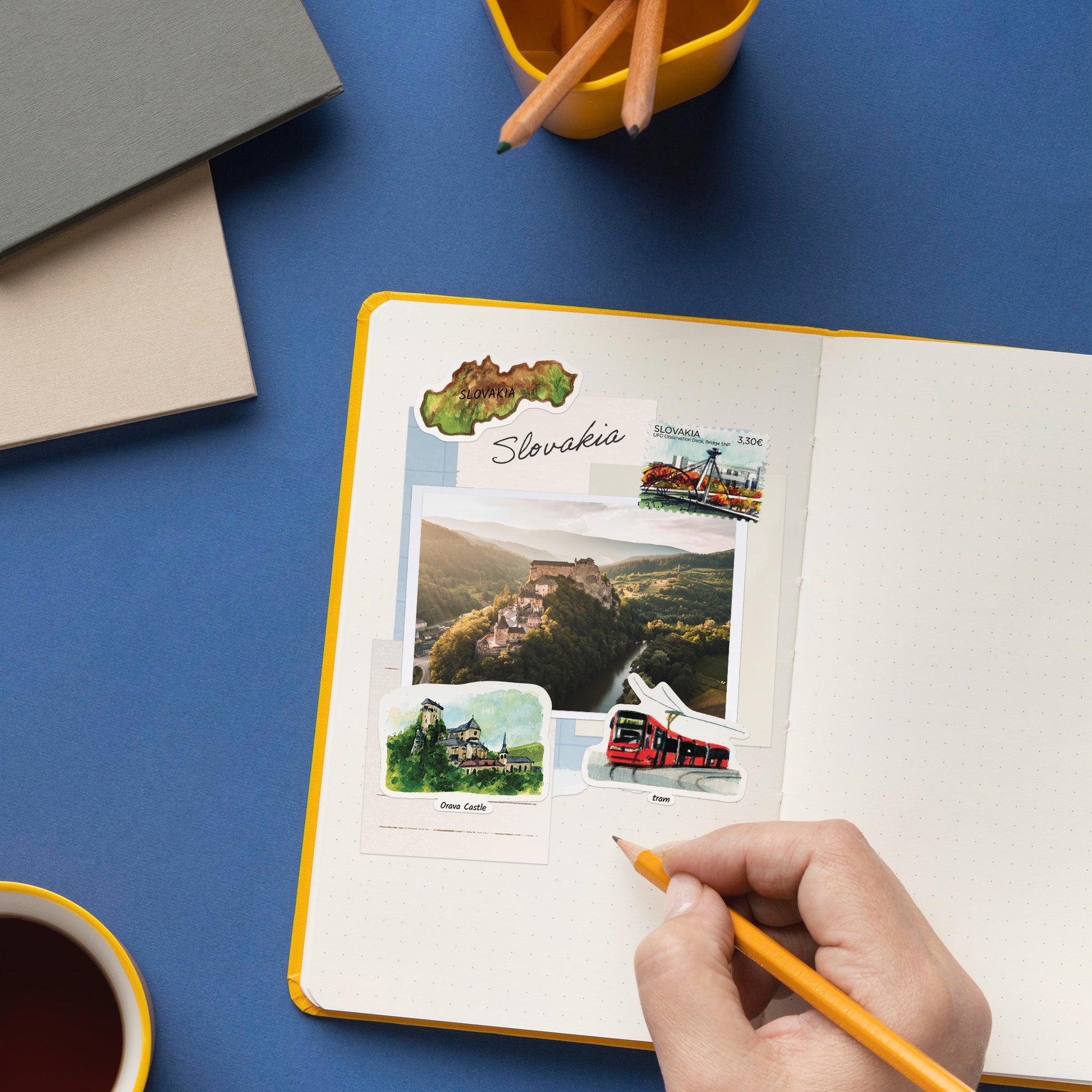 Slovakia map, Orava Castle and red tram stickers in a journal around a printed castle photo