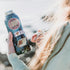 Hand holding a water bottle with THE LOOP Delmar, I heart STL and St. Louis-style ribs die-cut stickers.