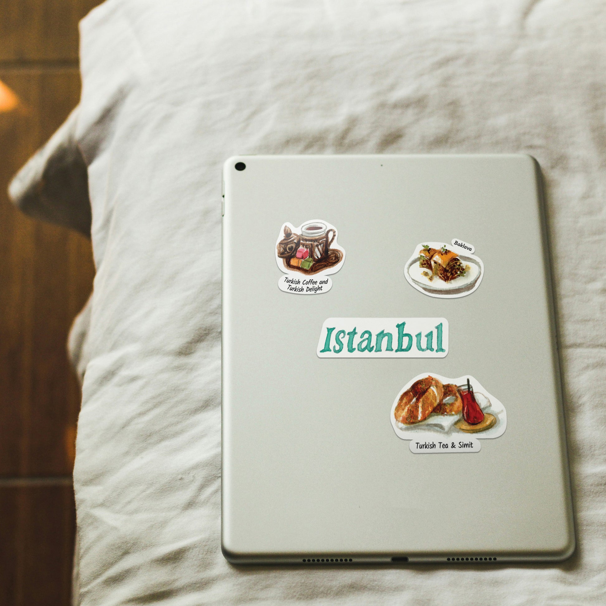 Turkish coffee, baklava and "Istanbul" stickers on a pale tablet back resting on linen