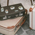 Ortakoy Mosque, tram and "SELAM!" stickers on a dark vintage suitcase stacked with a cream case