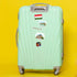 Hungarian flag, 'Hungary' label, Rubik's cube and landmark stickers on a mint suitcase against yellow