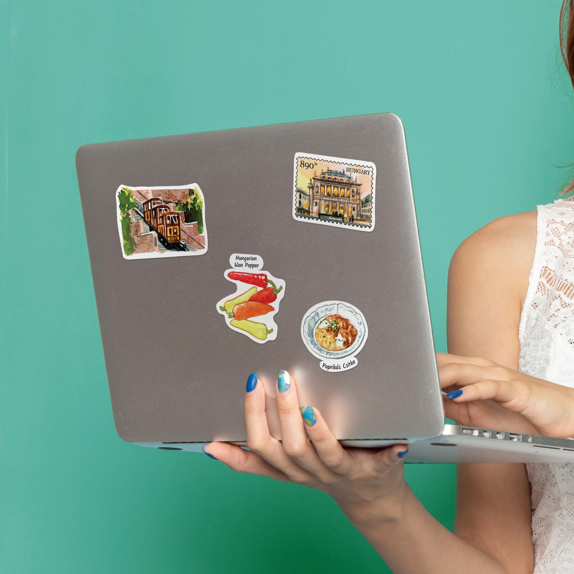 Funicular, wax pepper, paprikas csirke and Central Market Hall stickers on a grey laptop lid
