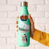 Goulash, Heroes' Square and folk costume stickers on a mint water bottle held against white brick