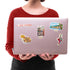 "LAKE COMO", Bellagio and Venetian jester stickers on a silver laptop lid held by a woman