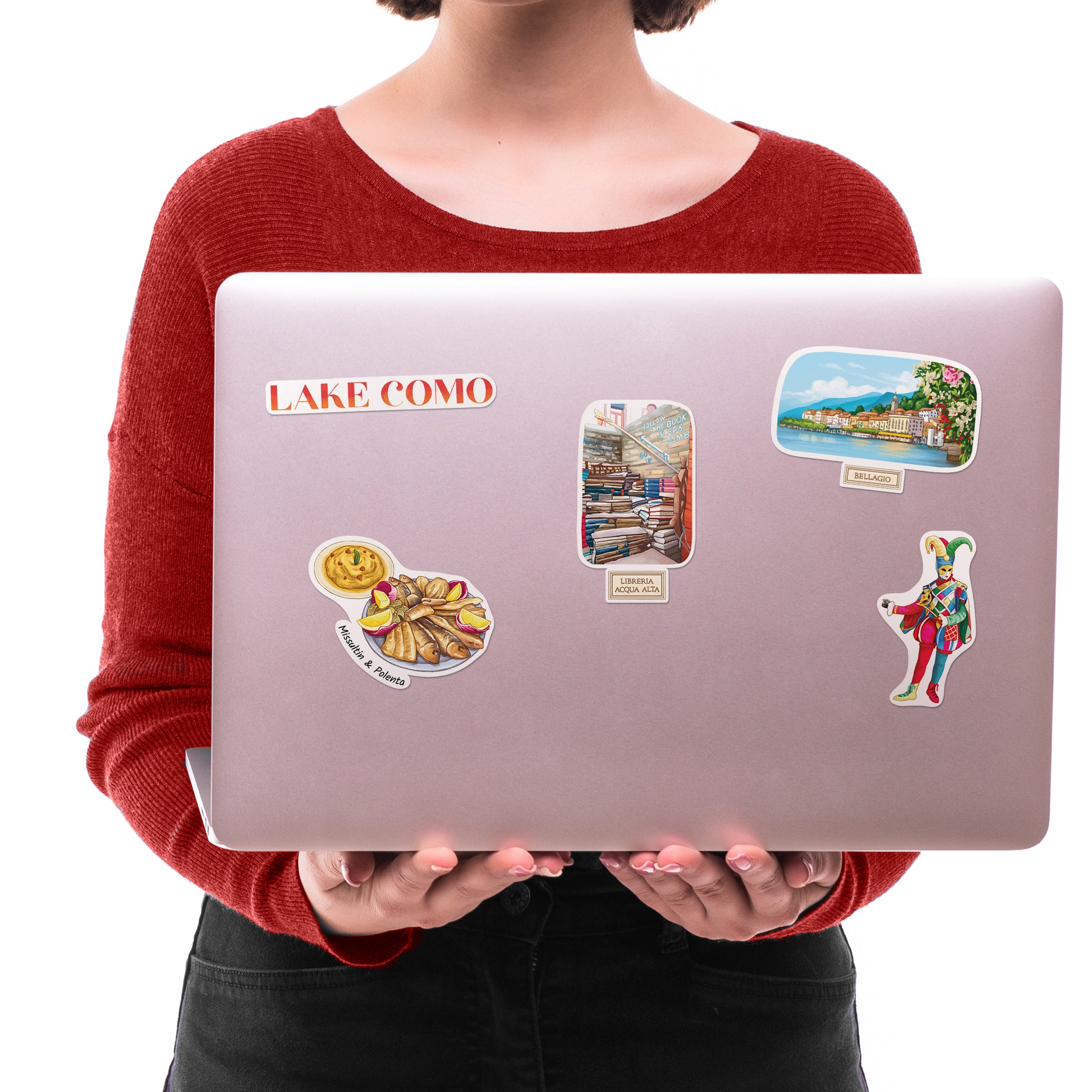 "LAKE COMO", Bellagio and Venetian jester stickers on a silver laptop lid held by a woman