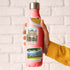 Risotto, Arco della Pace and Villa del Balbianello stickers on a pink water bottle held in one hand